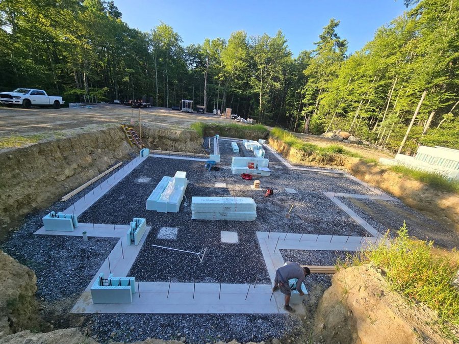 Poured footing with vertical rebar dowels and the first Nudura corner blocks being set